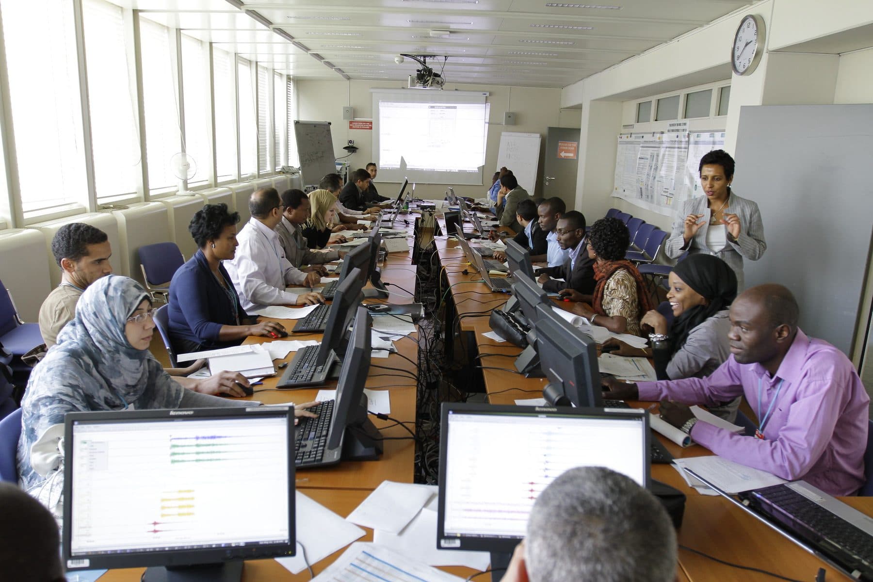 Trainees working at computers in a training room